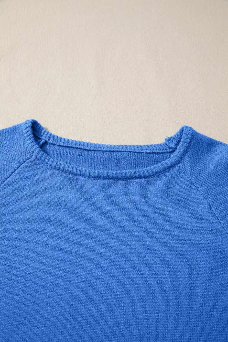 Close-up of blue Bell Sleeve Loose Knit Jumper neckline showing fine ribbed detailing and soft knit texture.