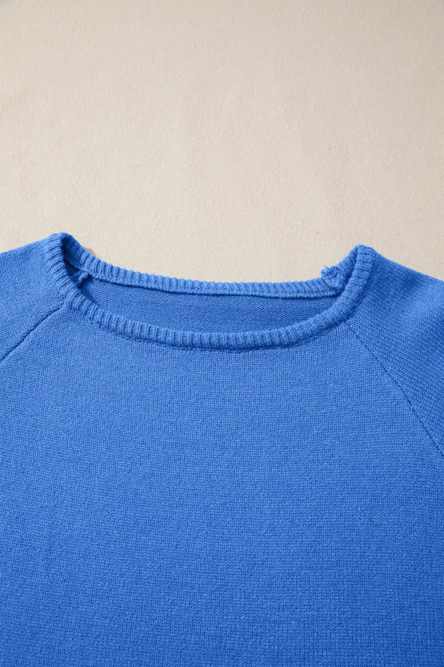 Close-up of blue Bell Sleeve Loose Knit Jumper neckline showing fine ribbed detailing and soft knit texture.