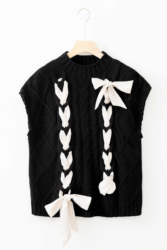 Flat lay of the black Satin Bowknot Short Sleeve Sweater with cream satin bows, showcasing its elegant cable knit and feminine accents.