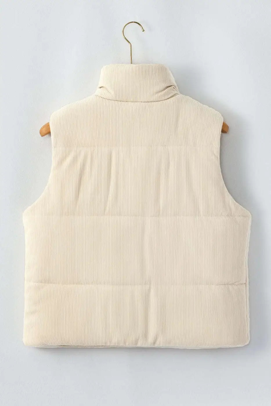 Back of ladies beige corduroy puffer gilet on hanger, featuring clean lines and padded winter vest design.