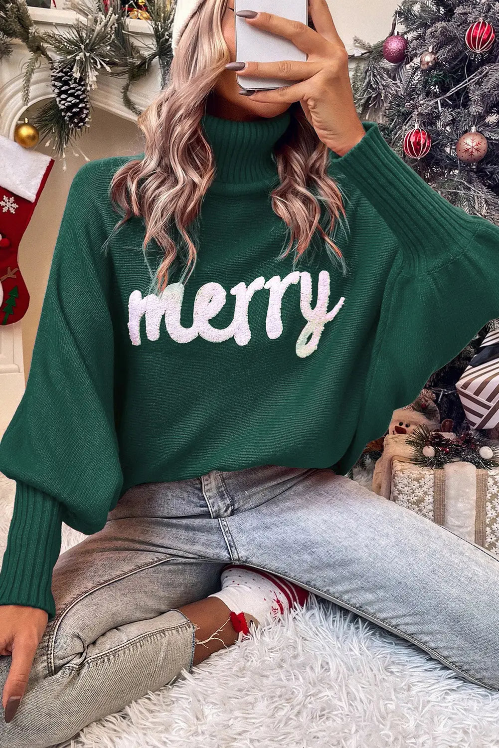 Green Stylish High Neck Red Sweater - Christmas with 'merry' print, styled casually with jeans and festive socks for a cozy holiday look.