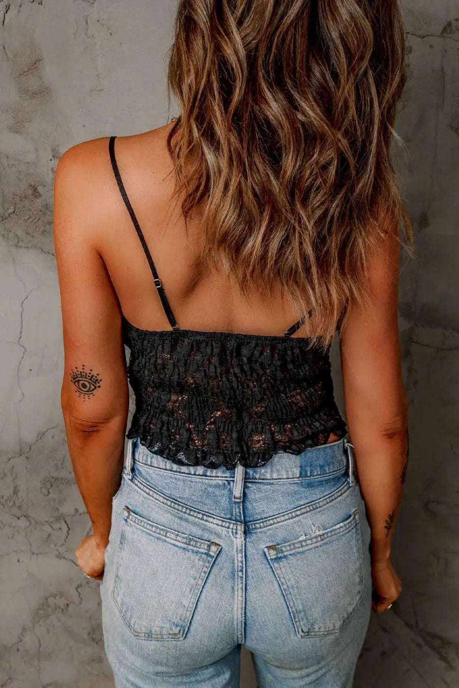 Back view of the Black Crochet Lace Bralette Crop Top showing smocked lace detailing and adjustable straps for a comfortable summer fit.