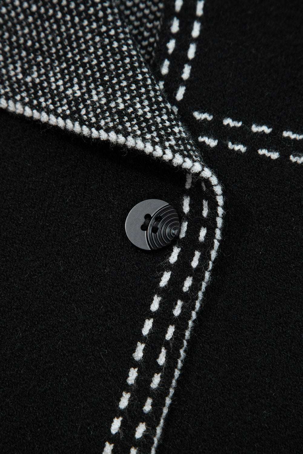 Close-up of button and inner lining on Women's Black Contrast Trim Knitted Cardigan, emphasizing quality stitching and craftsmanship.