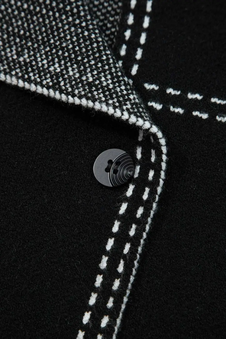 Close-up of button and inner lining on Women's Black Contrast Trim Knitted Cardigan, emphasizing quality stitching and craftsmanship.