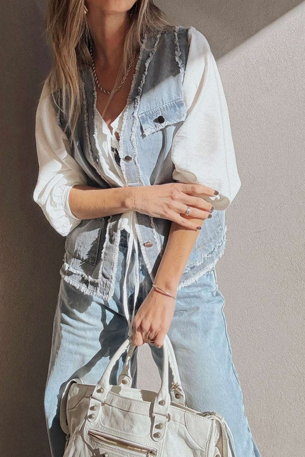 Beau Blue Denim Waistcoat with Frayed Edges layered over a white blouse, styled with light denim jeans and a white handbag for a chic outfit.