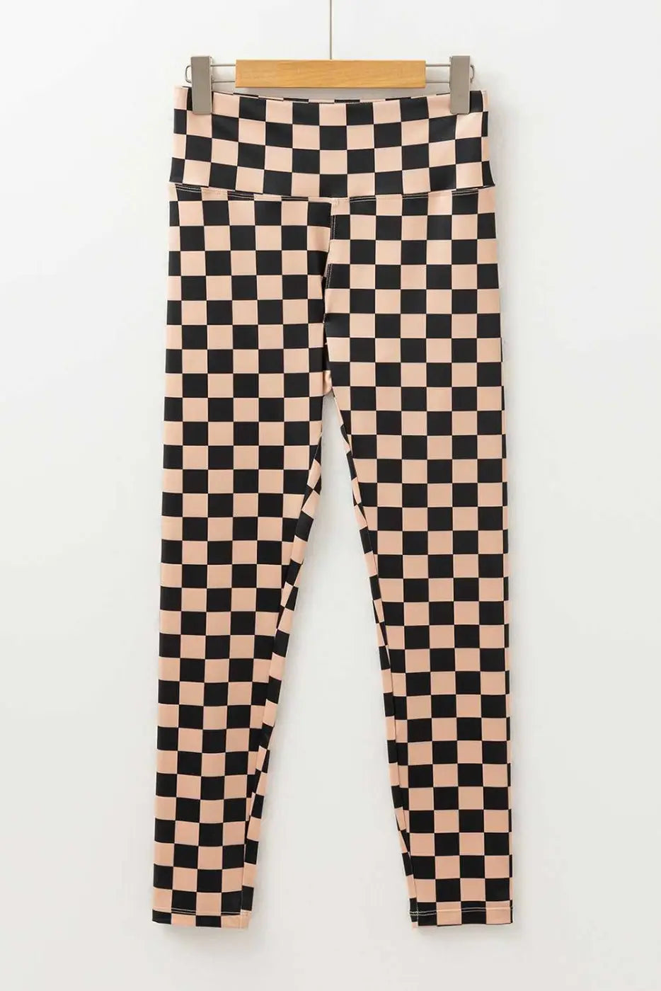 Flat lay of Checkered Skinny Leggings with high waist and tapered legs, showcasing their bold geometric print and sleek silhouette.