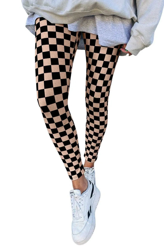 Checkered Skinny Leggings featuring a bold black and beige print, styled with white sneakers for a modern casual vibe.