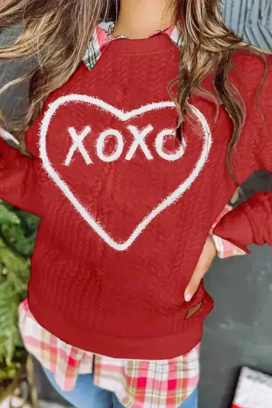Red Chenille Embroidered Sweatshirt with white heart and 'XOXO' text, styled with plaid shirt for Valentine's Day outfit.