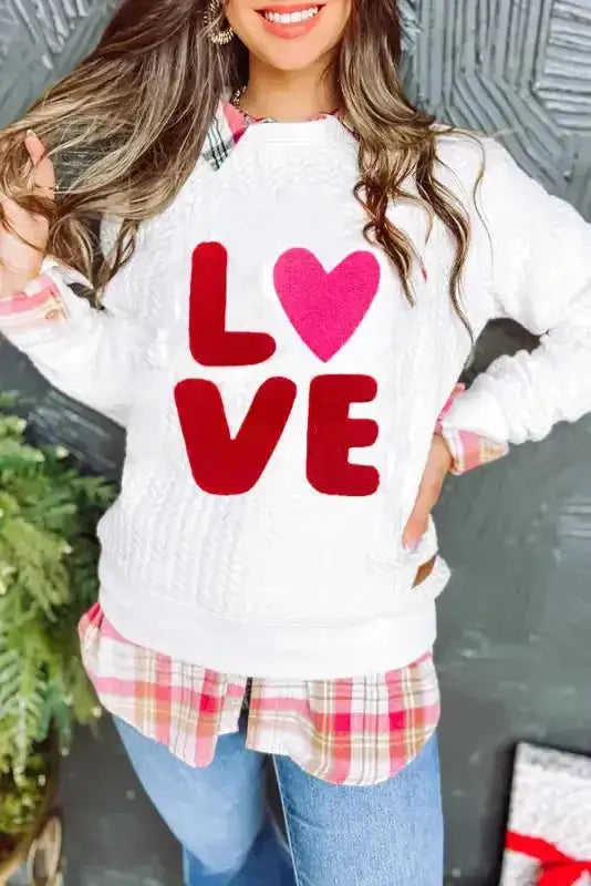 White Chenille Embroidered Sweatshirt with red 'LOVE' and pink heart design, layered over plaid shirt for Valentine's style.