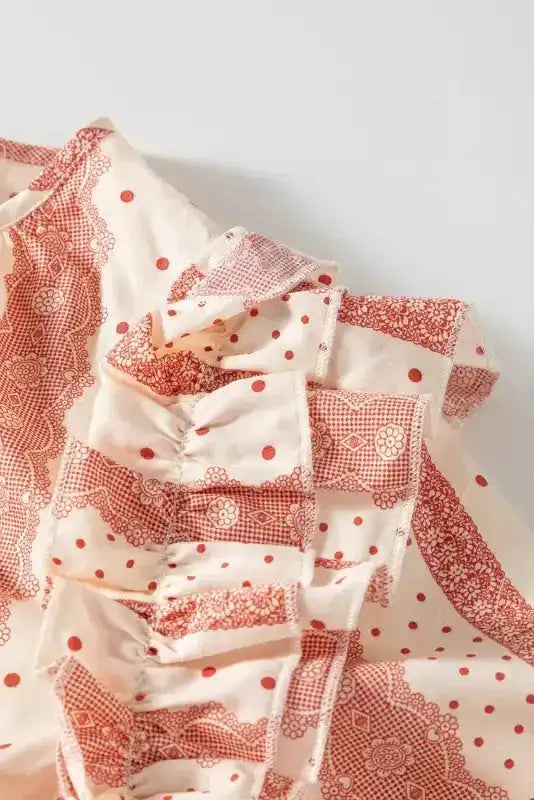 Close-up of ruffle shoulder design on Chic Peek Puff Sleeve Blouse, highlighting pink polka dot and lace stripe pattern.