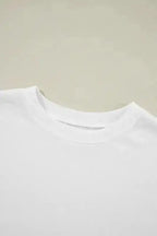 Close-up of white crewneck sweatshirt collar. Soft ribbed neckline enhances comfort and durability.