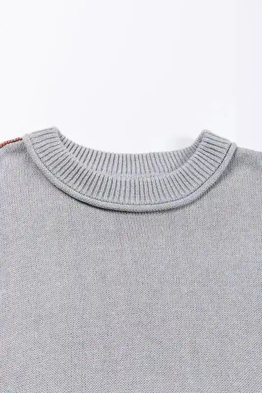 Close-up of the ribbed crew neckline on the Coffee Leopard Print Colorblock Pullover Sweater. Soft knit texture for added comfort and style.