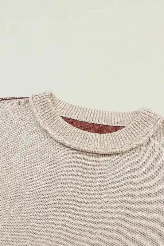 Close-up of ribbed neckline on Coffee Leopard Print Colorblock Pullover Sweater showing beige knit fabric and brown inner lining.