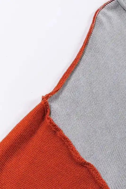 Detailed stitching of the shoulder seam on the Coffee Leopard Print Colorblock Pullover Sweater. Contrasting orange and grey panels enhance the colorblock effect.