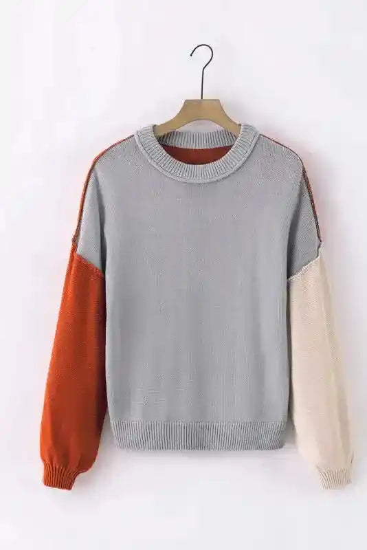Front view of Coffee Leopard Print Colorblock Pullover Sweater featuring grey body with orange and beige sleeves. A cozy and trendy fall top.