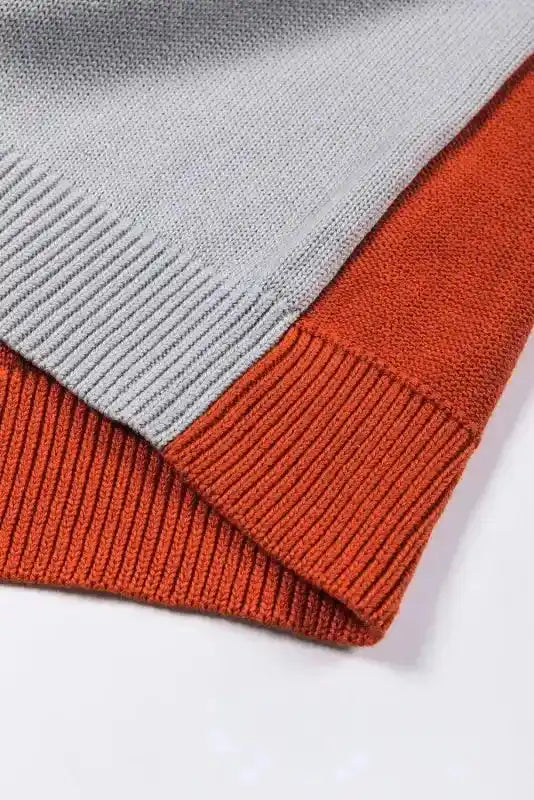 Bottom hem detail of Coffee Leopard Print Colorblock Pullover Sweater with ribbed knit in grey and orange. Durable and stylish finish.