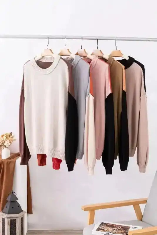 Assorted color options of the Coffee Leopard Print Colorblock Pullover Sweater hanging on a rack. Multiple trendy combinations for versatile styling.