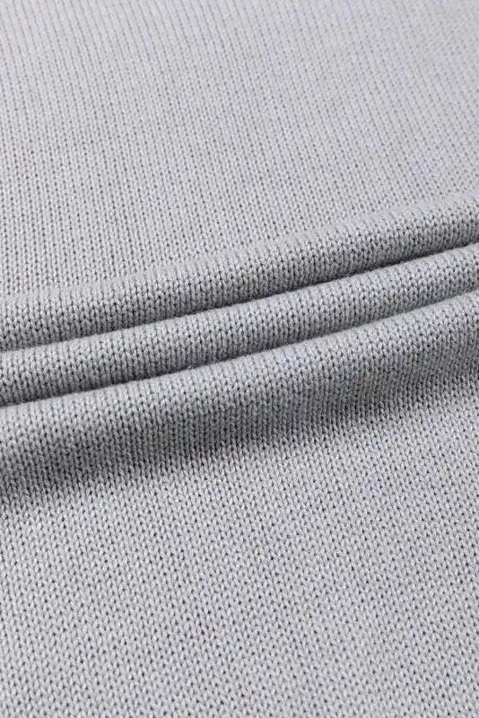 Flat lay of the grey knit fabric used in the Coffee Leopard Print Colorblock Pullover Sweater. Soft and breathable material for all-day comfort.