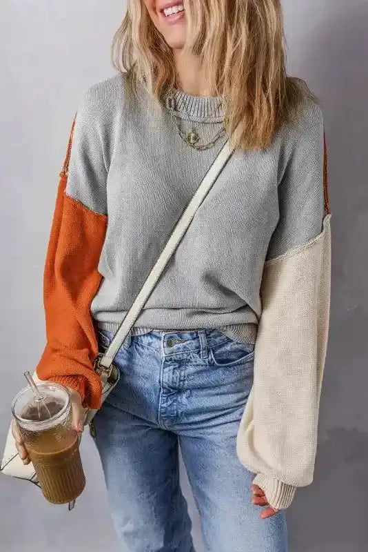 Model wearing Coffee Leopard Print Colorblock Pullover Sweater - New in gray, rust, and cream, holding iced coffee and styled with light denim.