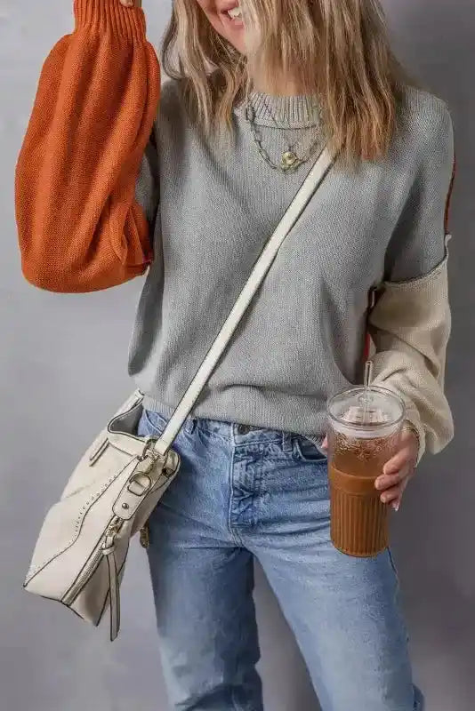 Model lifting rust sleeve of Coffee Leopard Print Colorblock Pullover Sweater - New, highlighting playful colorblock design.