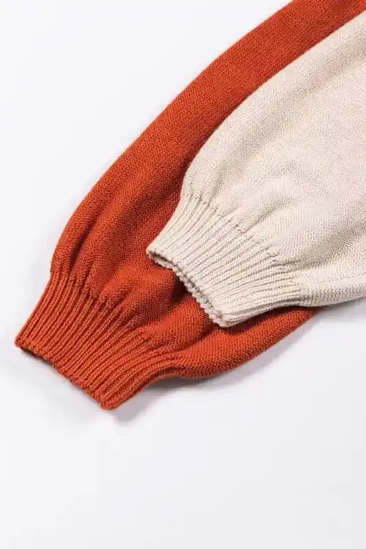 Close-up of the ribbed cuffs on the Coffee Leopard Print Colorblock Pullover Sweater. Features orange and beige sleeves with elastic fit.