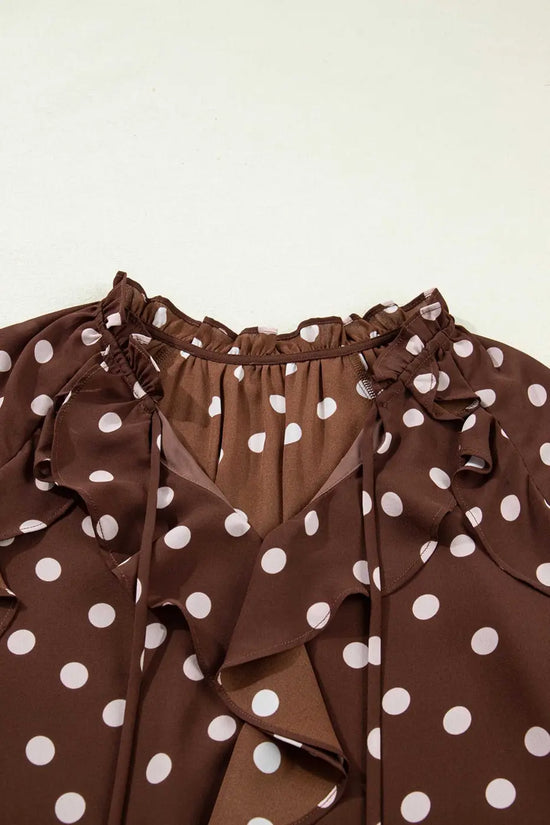 Close-up of the neckline on the coffee polka dot bell sleeve blouse, featuring a chiffon tie neck and soft ruffle trim for a feminine touch.