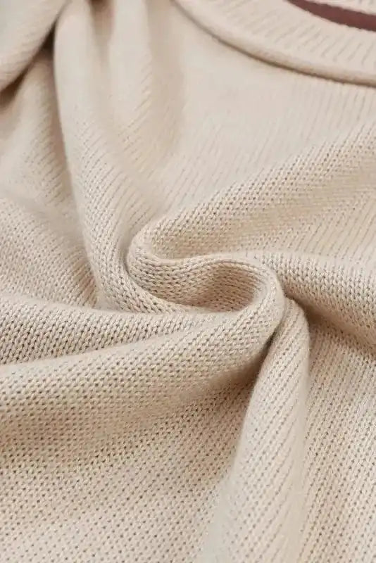 Fabric texture close-up of Colorblock Bishop Sleeve Sweater - Women's Sweaters at FashionFitz featuring soft beige knit material.