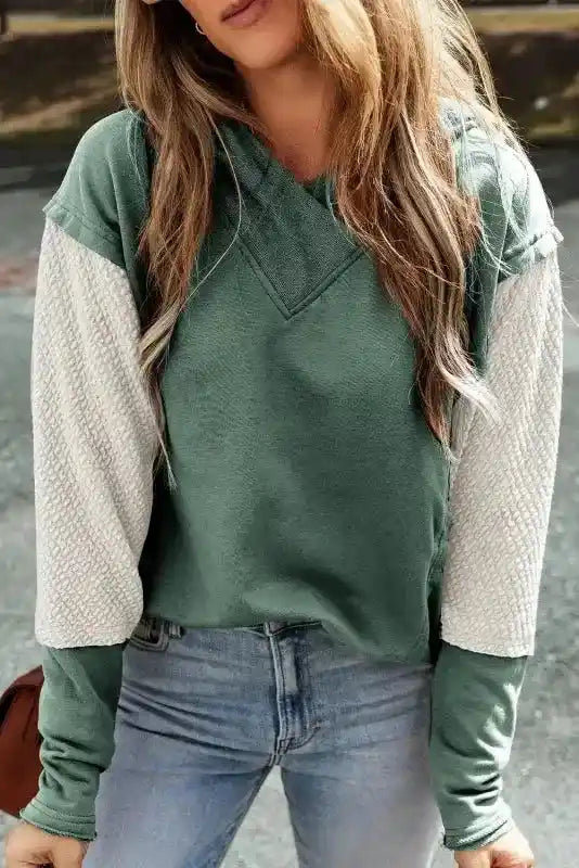 Green hoodie with beige colorblock sleeves, part of the Contrast Patchwork Hoodie collection for casual wear.