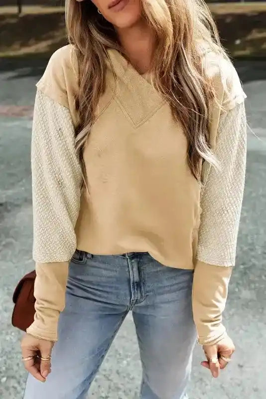Front view of Trendy Contrast Patchwork Hoodie featuring textured cream sleeves and beige body. Ideal for casual autumn outfits.
