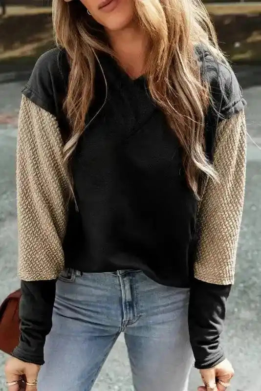 Front close-up of black Contrast Patchwork Hoodie with unique beige colorblock sleeves, perfect for casual outfits.