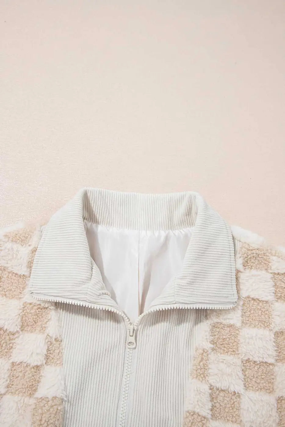 Light green corduroy jacket with a checkered pattern on a beige background