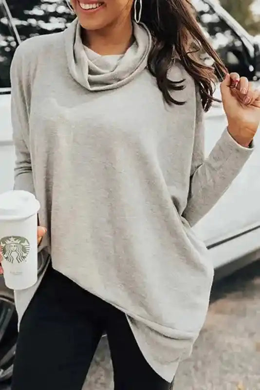 Light gray Cowl Neck Shift Tunic Top styled with black leggings and a coffee cup, perfect for a cozy and casual winter day.