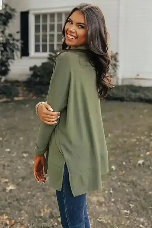 Side view of the olive green Versatile Cowl Neck Shift Tunic Top featuring a split hem and soft fabric, perfect for daily winter outfits.