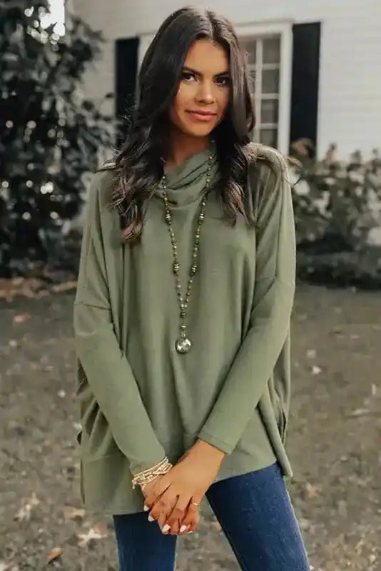 Front view of the olive green Cowl Neck Shift Tunic Top styled with jeans and accessories, offering a casual yet elegant winter look.
