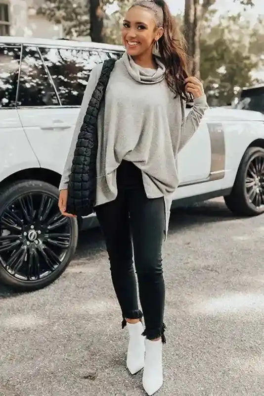 Full winter outfit with gray Cowl Neck Shift Tunic Top, black jeans, white boots, and a quilted bag, perfect for daily wear.