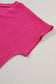 Bright pink textured short-sleeved top displayed on black crinkled v neck wide sleeve t-shirt