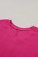 Bright pink v-neck sweater with textured knit pattern and crinkled v neck for a stylish look