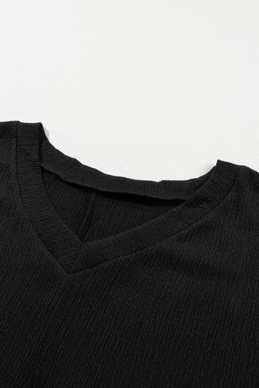 Black crinkled v neck wide sleeve t-shirt with textured knit pattern for a relax relax vibe