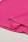 Bright pink textured fabric with a folded corner in black crinkled v neck wide sleeve t-shirt