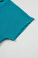 Edge of teal textured fabric on black crinkled v neck wide sleeve t-shirt for relax relax style