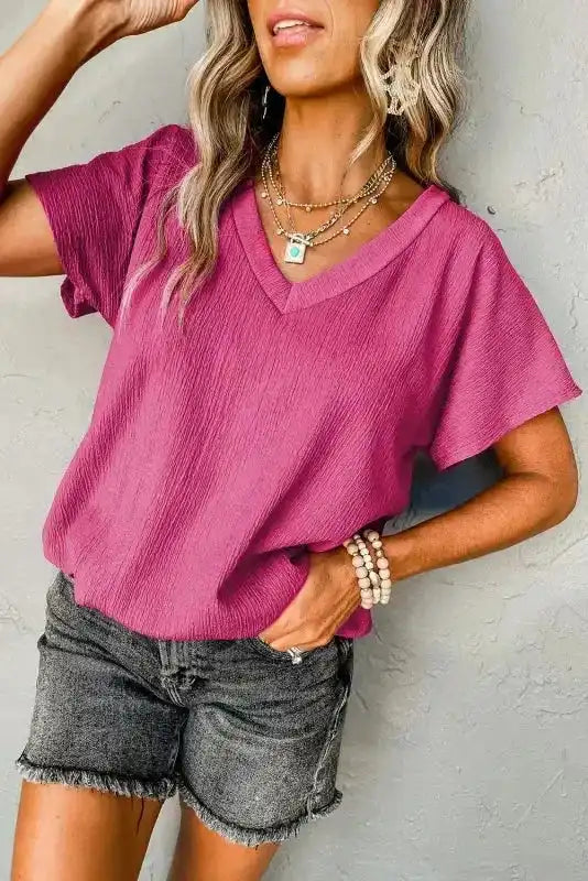 Side view of pink Crinkled V-Neck T-Shirt showing its relaxed fit and textured fabric, ideal for daily outfits.