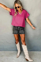 Model in pink Crinkled V-Neck T-Shirt and boots, styled for a fun and casual summer fashion look.