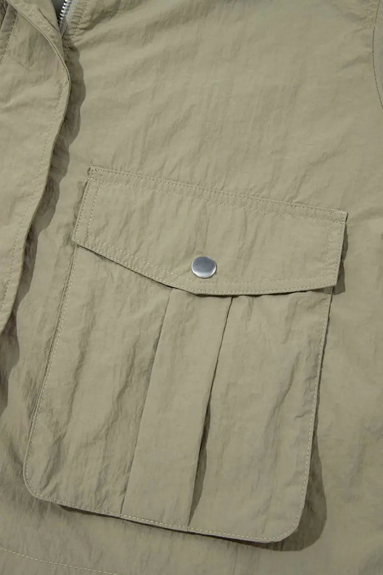 Front flap pocket with snap button on Cropped Hooded Utility Jacket, showcasing practical storage and solid color utility style.