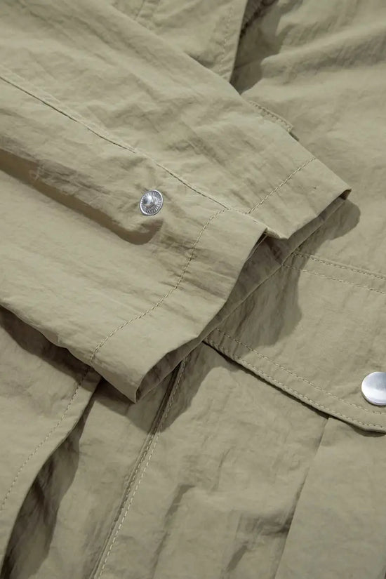 Sleeve and cuff detail of Cropped Hooded Utility Jacket with snap button, emphasizing durable stitching and casual design.