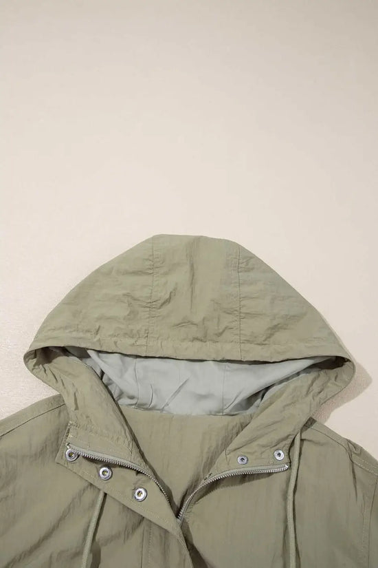 Close-up of adjustable hood on Cropped Hooded Utility Jacket in laurel green, emphasizing comfort and weather-ready design.