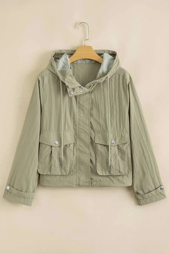 Laurel green Cropped Hooded Utility Jacket on hanger, featuring front zip, snap buttons, and flap pockets for functional outerwear appeal.