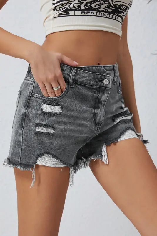 Crossover waist distressed gray denim shorts with rips and frayed edges for a relax relax vibe