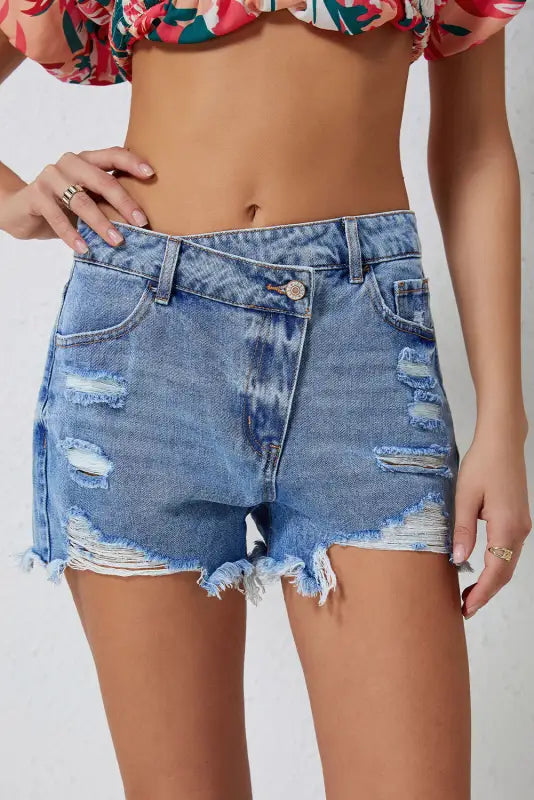 Crossover waist distressed denim shorts with frayed edges and rips. Relax relax relax style