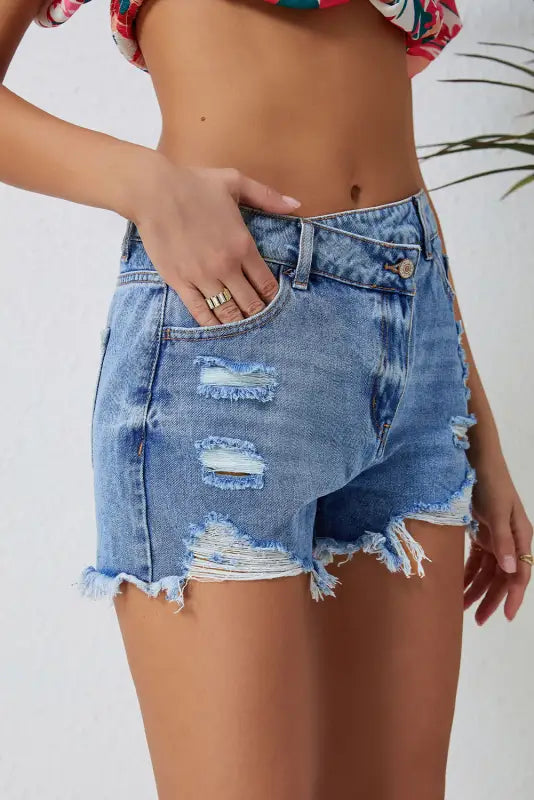 Crossover waist denim shorts with distressed rips and frayed edges for a relax relax style