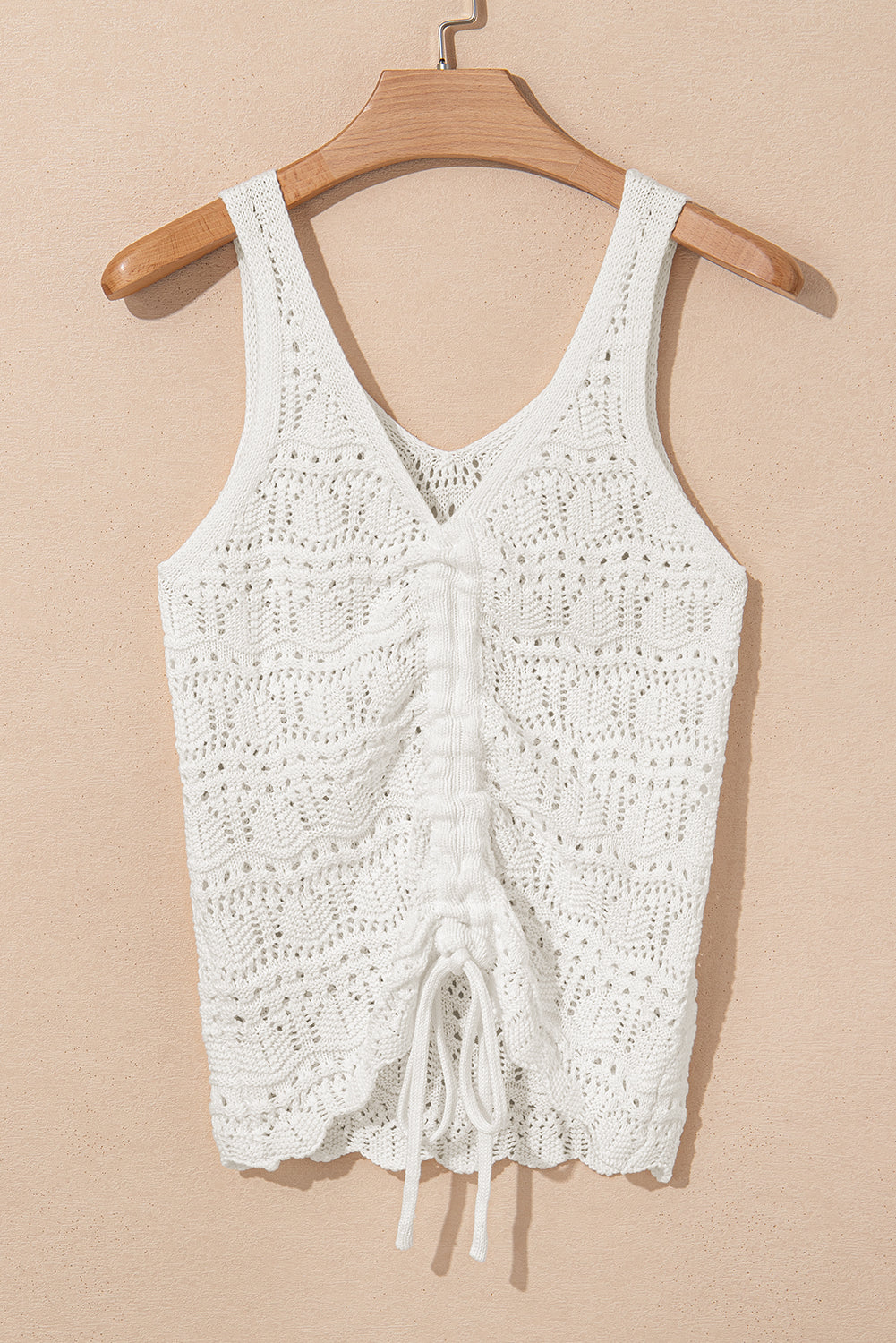 Flat lay of glamour crochet tank top on hanger, featuring breathable knit texture and adjustable drawstring for versatile summer styling.